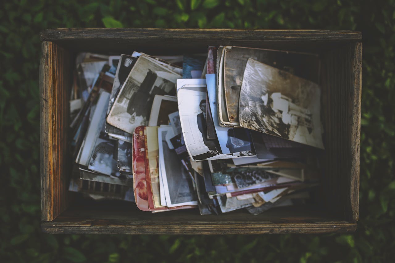 A nostalgic collection of vintage photos in an old wooden box.